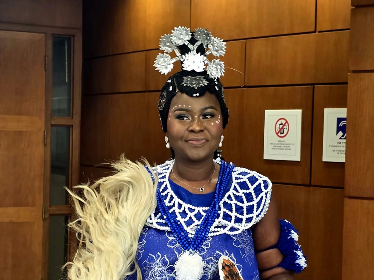 Aunty Didi in traditional ceremonial attire, with a beaded collar and headdress